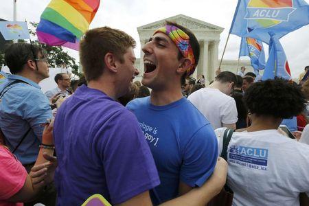 Gay rights supporters celebrate after the U.S. Supreme Court ruled that the U.S. Constitution provides same-sex couples the right to marry, outside the Supreme Court building in Washington, June 26, 2015.   REUTERS/Jim Bourg