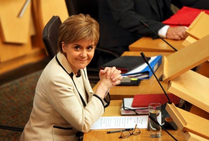 Scotland's First Minister Nicola Sturgeon listens in the debating chamber of the Scottish Parliament at Holyrood in Edinburgh, Scotland, Britain June 28, 2016.  REUTERS/Scott Heppell